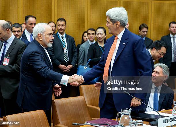 Foreign Minister of Iran, Mohammad Javad Zarif shakes hands with US Secretary of State John Kerry at the last working session of E 3+3 negotiations...