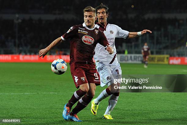 Ciro Immobile of Torino FC is challenged by Paolo Castellini of AS Livorno Calcio during the Serie A match between Torino FC and AS Livorno Calcio at...