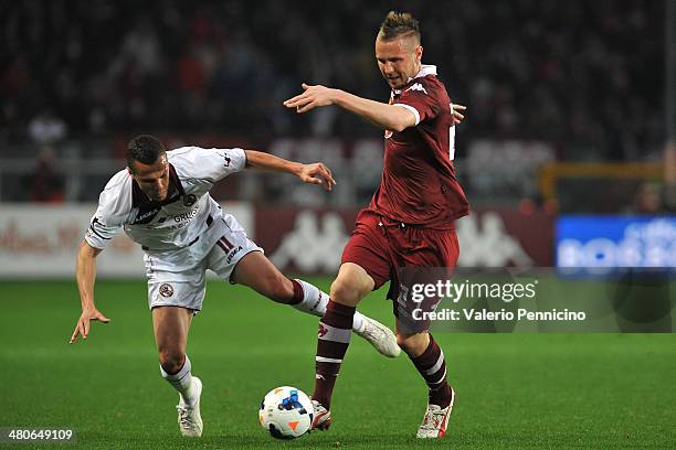 Jasmin Kurtic of Torino FC clashes with Djamel Mesbah of AS Livorno Calcio during the Serie A match between Torino FC and AS Livorno Calcio at Stadio...