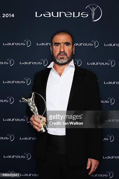 Eric Cantona poses with the Laureus trophy during the 2014 Laureus World Sports Awards at the Istana Budaya Theatre on March 26, 2014 in Kuala...