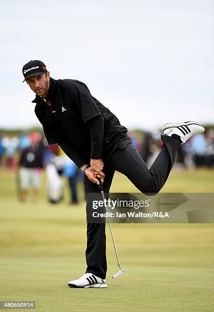 Dustin Johnson of the United States reacts to a putt during practice ahead of the 144th Open Championship at The Old Course on July 14, 2015 in St...