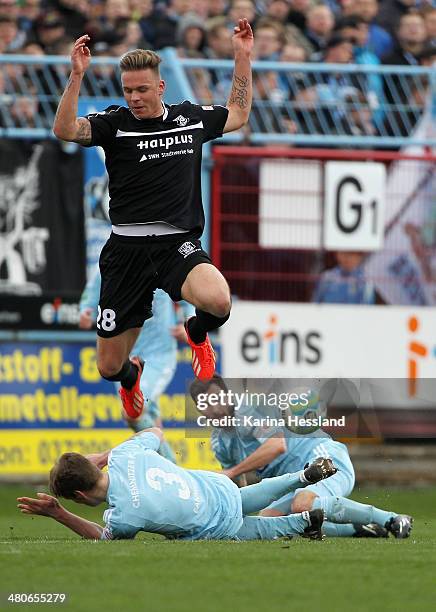 Silvio Bankert and Sascha Pfeffer of Chemnitz on the ground, Marcel Franke of Halle jumpes over Silvio Bankert of Chemnitz during the third Liga...