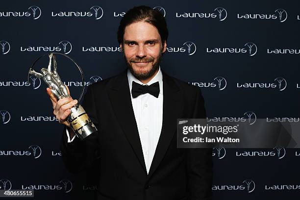 Daniel Bruhl poses with the Laureus trophy during the 2014 Laureus World Sports Awards at the Istana Budaya Theatre on March 26, 2014 in Kuala...