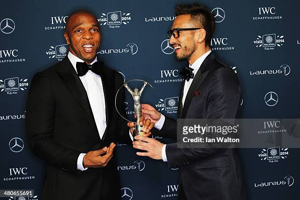 Hidetoshi Nakata with Quinton Fortune hold the Laureus trophy during the 2014 Laureus World Sports Awards at the Istana Budaya Theatre on March 26,...
