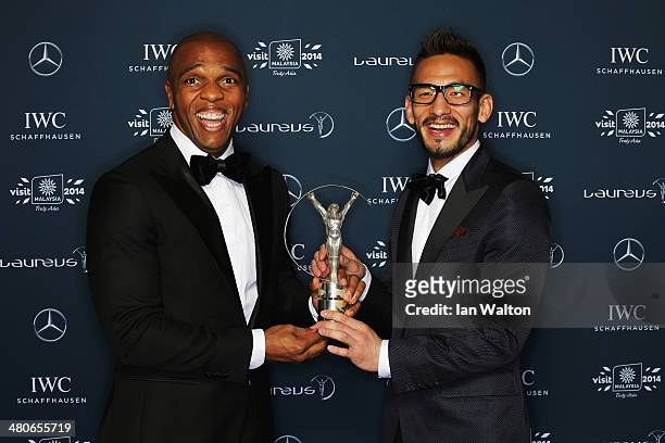 Hidetoshi Nakata with Quinton Fortune hold the Laureus trophy during the 2014 Laureus World Sports Awards at the Istana Budaya Theatre on March 26,...