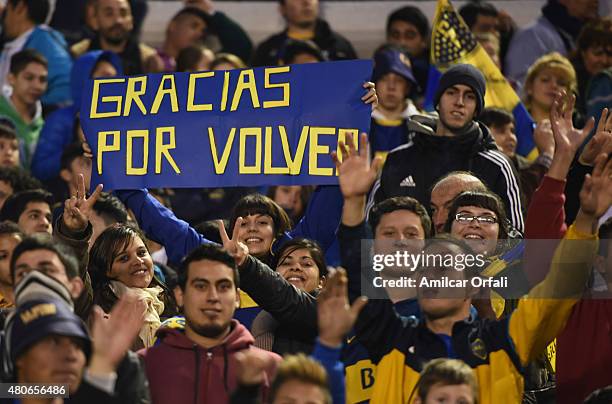 Fan shows a sign with the words "Gracias por volver" during Carlos Tevez presentation as new player of Boca Juniors at Alberto J. Armando Stadium on...