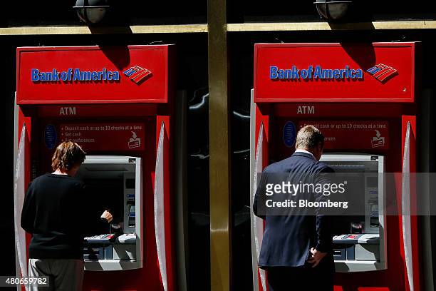 Customers use Bank of America Corp. ATMs outside of a branch in Los Angeles, California, U.S., on Monday, July 13, 2015. Bank of America Corp. Is...