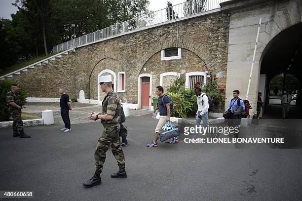 Volunteers for French Foreign Legion walk with soldiers at the recruitment center in Fontenay-sous-bois, outside Paris on June 22, 2015. Thousands of...