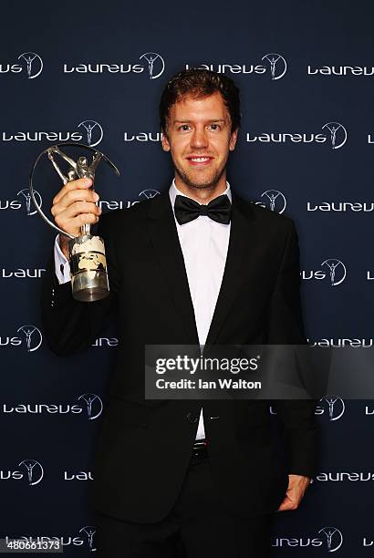 Sebastian Vettel winner of the Laureus World Sportsman of the Year award poses with their trophy during the 2014 Laureus World Sports Awards at the...