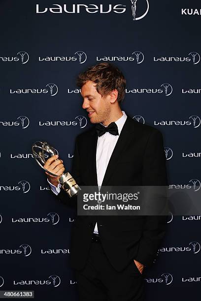 Sebastian Vettel winner of the Laureus World Sportsman of the Year award poses with their trophy during the 2014 Laureus World Sports Awards at the...