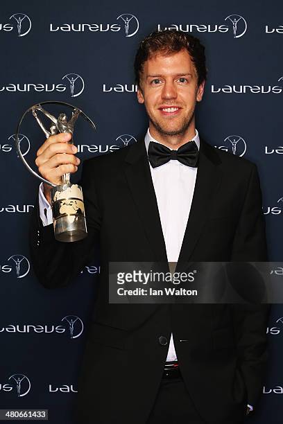 Sebastian Vettel winner of the Laureus World Sportsman of the Year award poses with their trophy during the 2014 Laureus World Sports Awards at the...