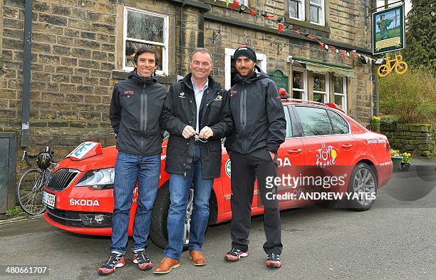 Multi time Tour De France winner Bernard Hinault poses for a photograph with Russell and Dean Downing at the Robin Hood Inn at Cragg Vale, Englands...