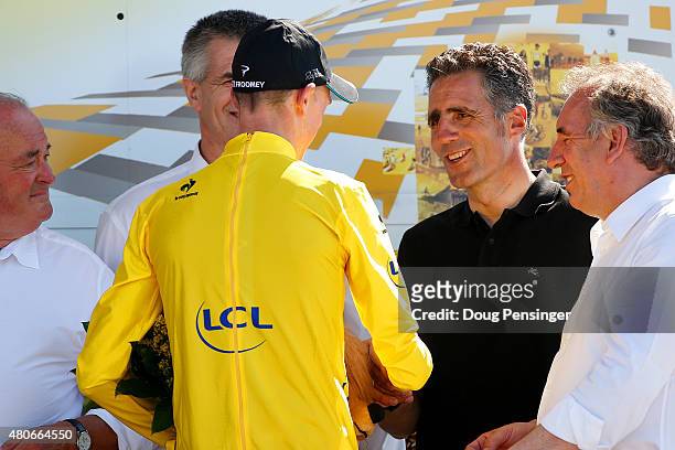 Chris Froome of Great Britain and Team Sky shakes hands with former cyclist Miguel Indurain after winning stage ten of the 2015 Tour de France, a 167...