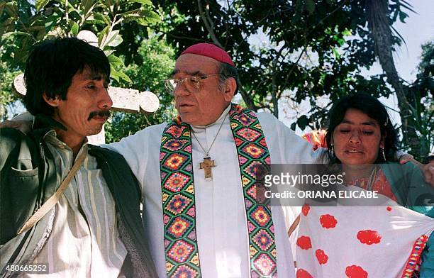 Bishop Samuel Ruiz of San Cristobal consoles two Tzotzil Indians during funeral ceremonies for 45 of their compatriots in Acteal, Mexico, December...
