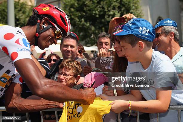 Daniel Teklehaimanot of Eritrea and MTN-Qhubeka signs autographs for fans at the start of stage ten of the 2015 Tour de France, a 167 km stage...