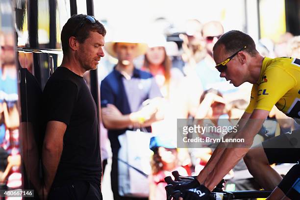 Tim Kerrison, Head of Athlete Performance at Team Sky watches as Chris Froome of Great Britain and Team Sky prepares before stage ten of the 2015...