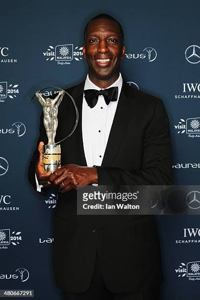 Laureus Academy member Michael Johnson poses with the trophy during the 2014 Laureus World Sports Awards at the Istana Budaya Theatre on March 26,...