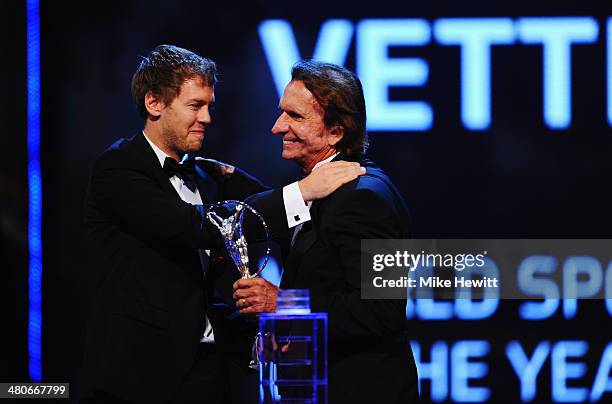 Formula One Driver Sebastian Vettel receives the Laureus World Sportsman of the Year Award from Laureus Academy member Emerson Fittipaldi during the...