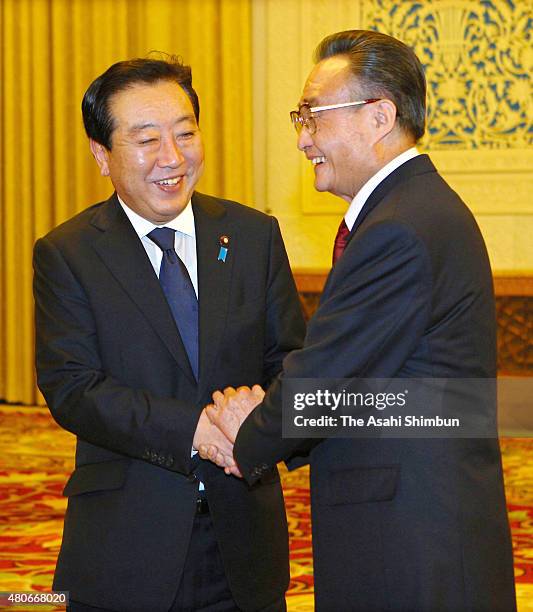 Japanese Prime Minister Yoshihiko Noda and Standing Committee of the National People's Congress Chairman Wu Bangguo shake hands during their meeting...