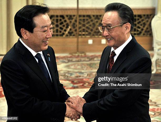 Japanese Prime Minister Yoshihiko Noda and Standing Committee of the National People's Congress Chairman Wu Bangguo shak hands at the Great Hall of...