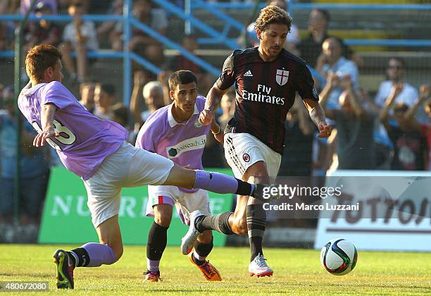 Alessio Cerci of AC Milan is challenged during the preseason friendly match between AC Milan and Legnano on July 14, 2015 in Solbiate Arno, Italy.