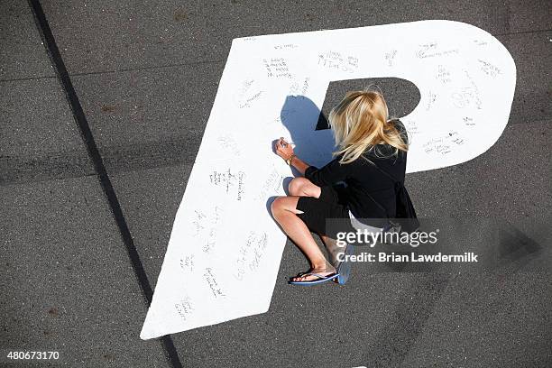 Race fan signs the track during the NASCAR Sprint Cup Series Axalta 'We Paint Winners' 400 at Pocono Raceway on June 7, 2015 in Long Pond,...