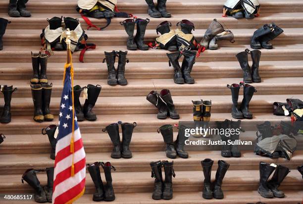 Firefighter boots line the stairs inside San Francisco City Hall during a remembrance ceremony held for San Francisco firefighters who have died of...
