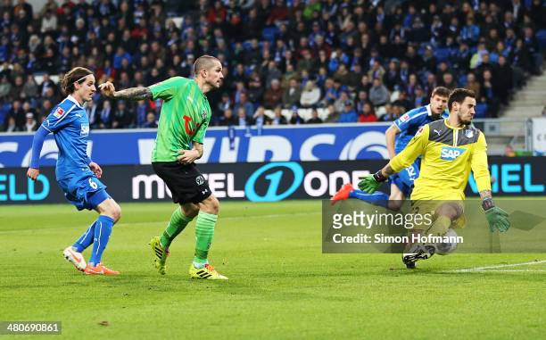 Leon Andreasen of Hannover scores his team's first goal against goalkeeper Jens Grahl of Hoffenheim during the Bundesliga match between 1899...