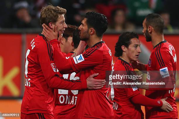 Stefan Kiessling of Leverkusen celebrates scoring the opening goal with his team mate Emre Can ring the Bundesliga match between FC Augsburg and...