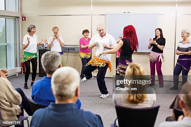 senior man dancing belly dance - belly dancing stock pictures, royalty-free photos & images