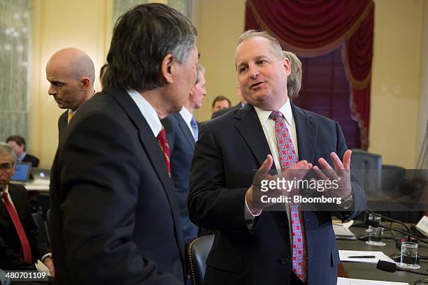 John Mulligan, executive vice president and chief financial officer of Target Corp., right, talks to Wallace Loh, president of the University of...