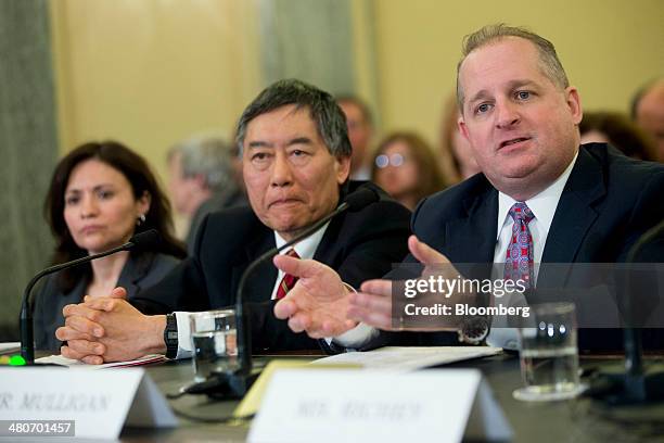 John Mulligan, executive vice president and chief financial officer of Target Corp., from right, Wallace Loh, president of the University of...