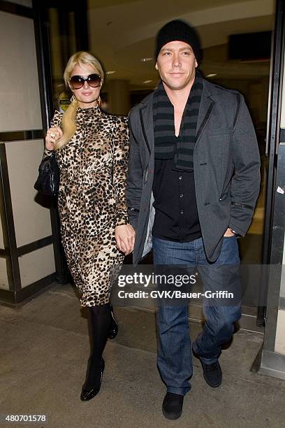 Paris Hilton and Cy Waits are seen at Los Angeles International Airport on February 19, 2011 in Los Angeles, California.
