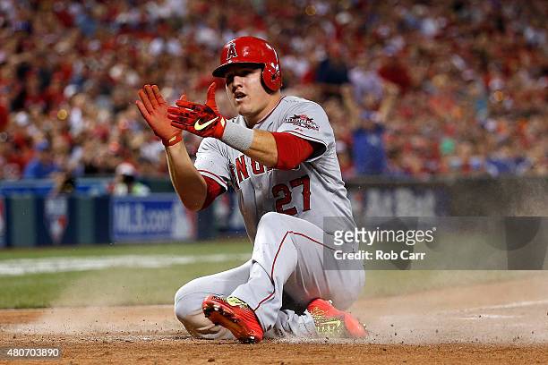 American League All-Star Mike Trout of the Los Angeles Angels of Anaheim celebrates after scoing off of American League All-Star Prince Fielder of...