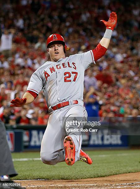 American League All-Star Mike Trout of the Los Angeles Angels of Anaheim slides home to score off of American League All-Star Prince Fielder of the...