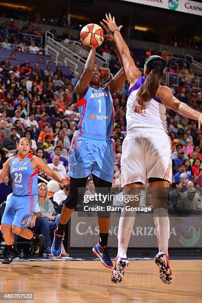 DeLisha Milton-Jones of the Atlanta Dream shoots against Mistie Bass of the Phoenix Mercury on July 14, 2015 at Talking Stick Resort Arena in...