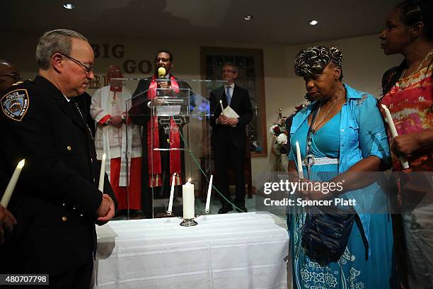 Gwen Carr, the mother of Eric Garner , stands with Staten Island Borough Commander Chief Edward Delatorre in a joint candle lighting at an interfaith...