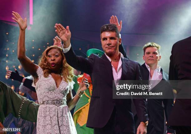 Simon Cowell bows with cast members Cynthia Erivo and Nigel Harman at the curtain call during the press night performance of "I Can't Sing! The X...