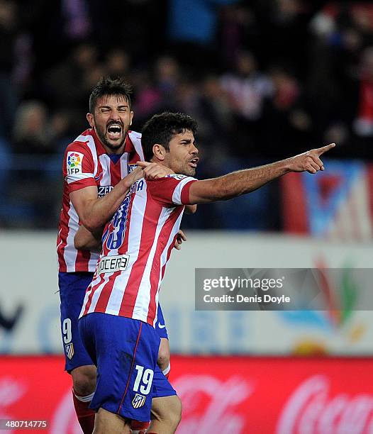 Diego Costa of Club Atletico de Madrid celebrates with David Villa after scoring his team's opening goal during the La Liga match between Club...