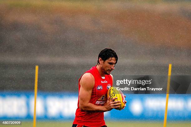 Ryan Griffen runs with the ball during a Western Bulldogs AFL training session at Whitten Oval on March 27, 2014 in Melbourne, Australia.