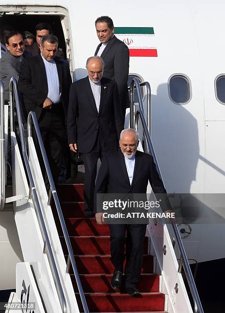 Iranian Foreign Minister Mohammad Javad Zarif and the head of Iran's Atomic Energy Organization Ali Akbar Salehi arrive at Tehran's Mehrabad Airport...