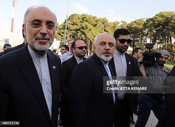 Iranian Foreign Minister Mohammad Javad Zarif and the head of Iran's Atomic Energy Organization Ali Akbar Salehi arrive at Tehran's Mehrabad Airport...