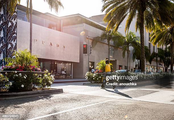 woman crossing street in beverly hills, prada store - rodeo drive bildbanksfoton och bilder