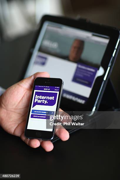 Internet Party CEO Vikram Kumar shows the sign up app on his smartphone after the Internet Party was launched by Kim Dotcom at the Dotcom Mansion on...