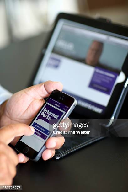 Internet Party CEO Vikram Kumar shows the sign up app on his smartphone after the Internet Party was launched by Kim Dotcom at the Dotcom Mansion on...