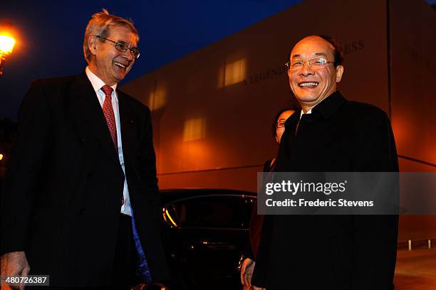 Philippe Varin , chairman of the PSA Peugeot Citroen, and Xu Ping , chairman of the board of directors of Dongfeng, smile after a news conference on...