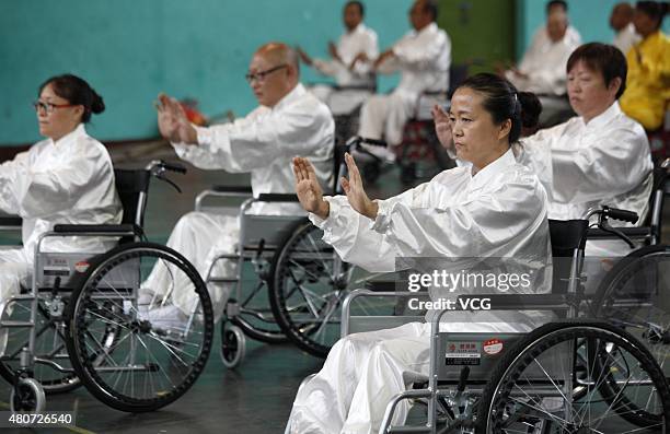 People with lower-limb disabilities sitting in wheelchairs play Tai Chi Chuan in Xuanhua District on July 15, 2015 in Zhangjiakou, Hebei Province of...