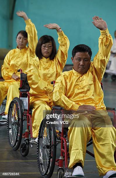 People with lower-limb disabilities sitting in wheelchairs play Tai Chi Chuan in Xuanhua District on July 15, 2015 in Zhangjiakou, Hebei Province of...