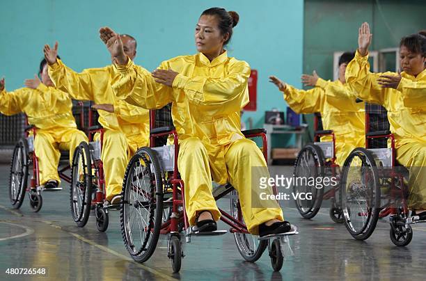 People with lower-limb disabilities sitting in wheelchairs play Tai Chi Chuan in Xuanhua District on July 15, 2015 in Zhangjiakou, Hebei Province of...