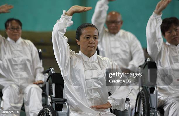 People with lower-limb disabilities sitting in wheelchairs play Tai Chi Chuan in Xuanhua District on July 15, 2015 in Zhangjiakou, Hebei Province of...